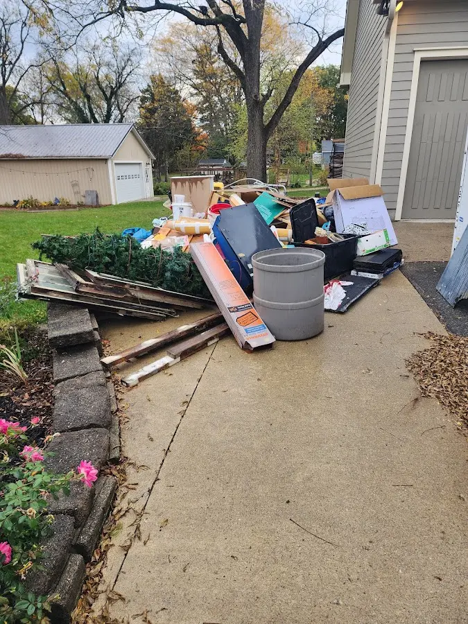 Dumpster being loaded with debris for Estate Cleanout Dumpster Rental in Palmer